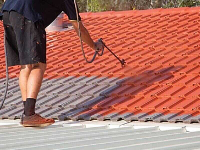 person-painting-a-roof-tile-with-an-airless-sprayer